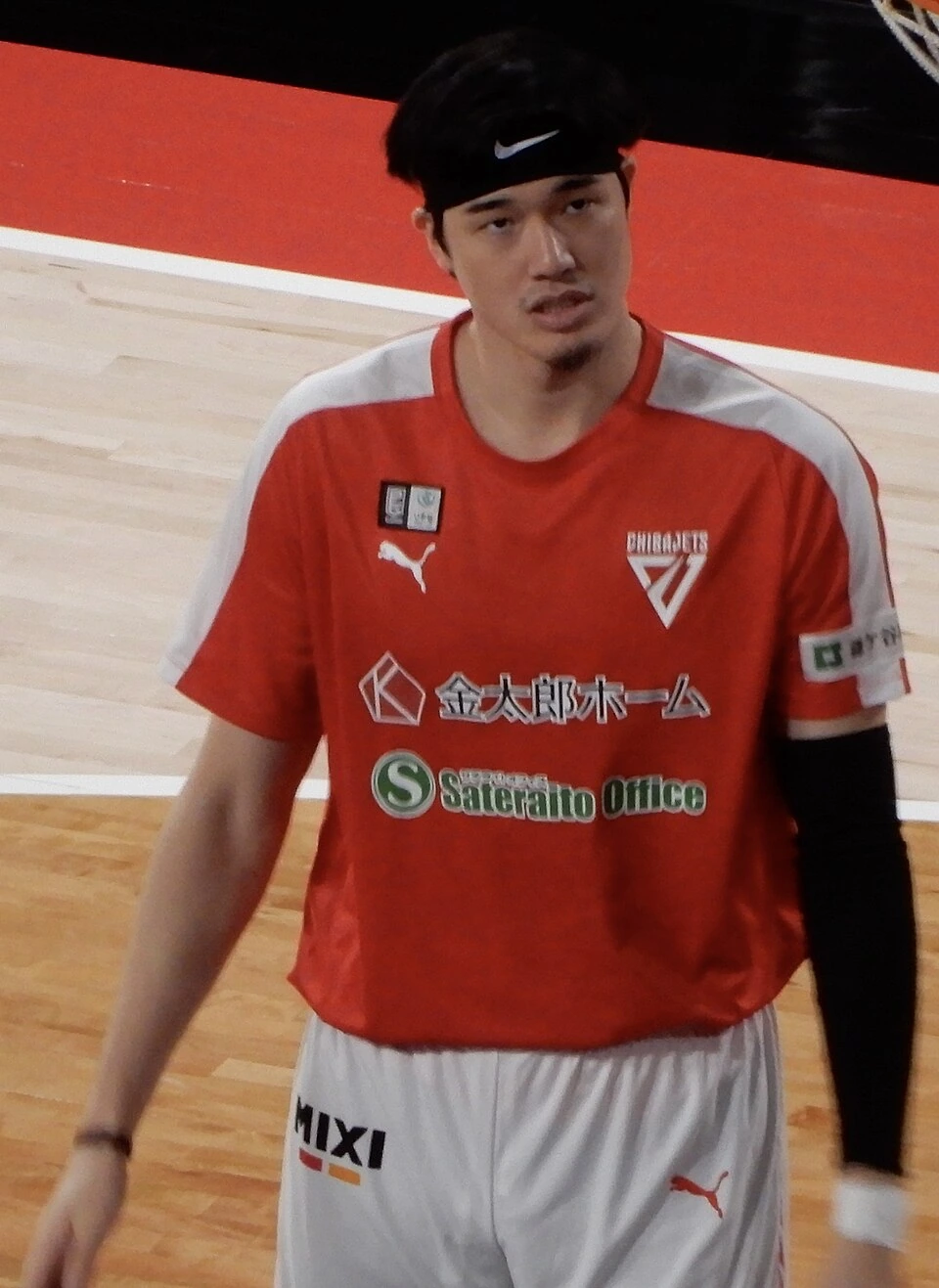 Yuta Watanabe in a red basketball uniform on the court