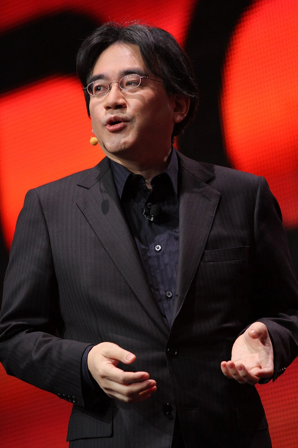 Satoru Iwata speaking on stage at the Game Developers Conference 2011