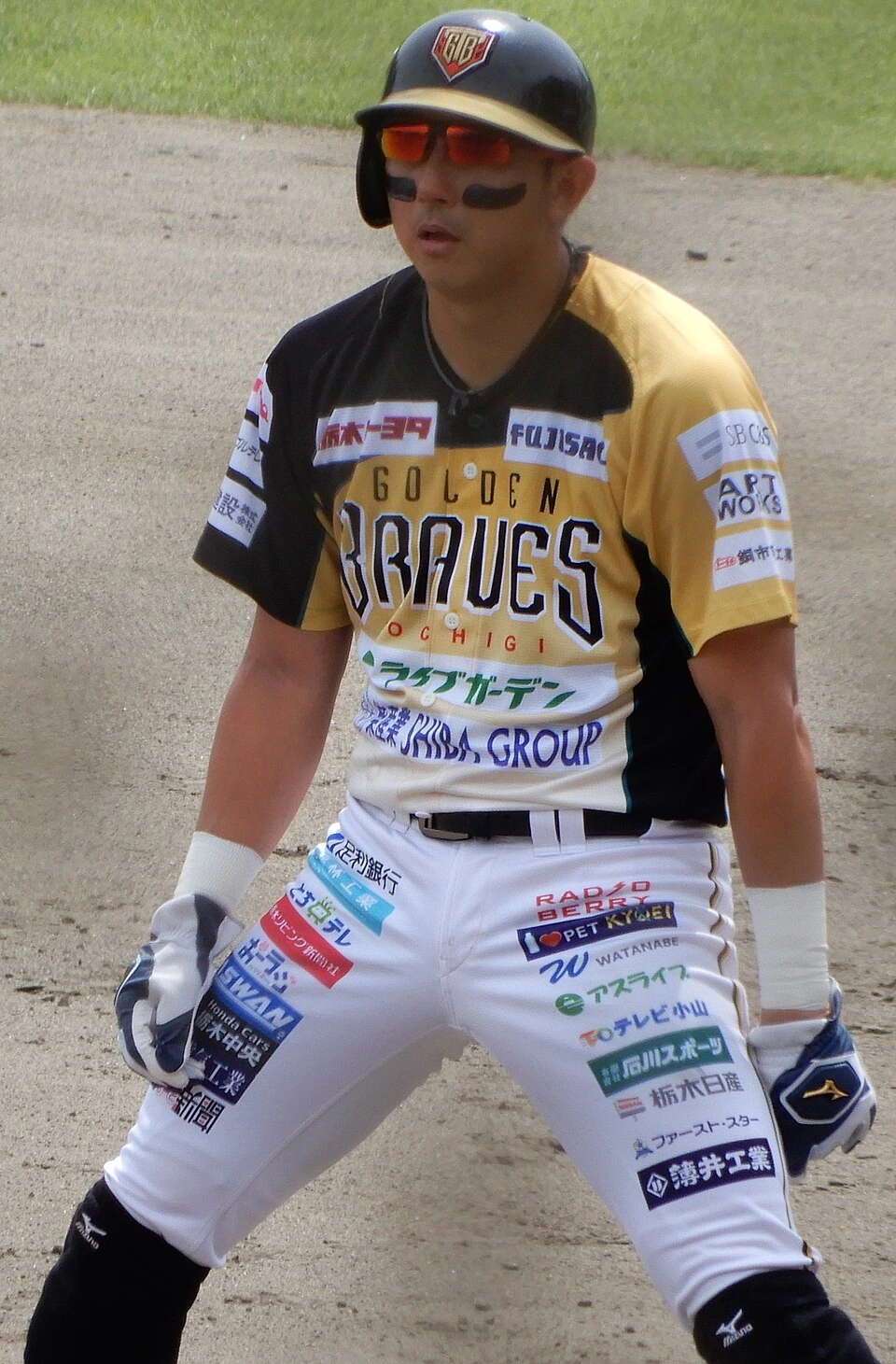 Munenori Kawasaki in a baseball uniform standing on the field