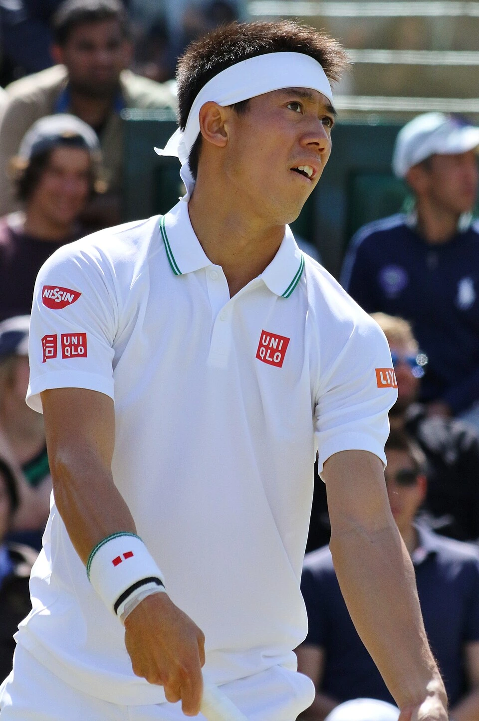 Kei Nishikori during a tennis match in a white shirt and headband