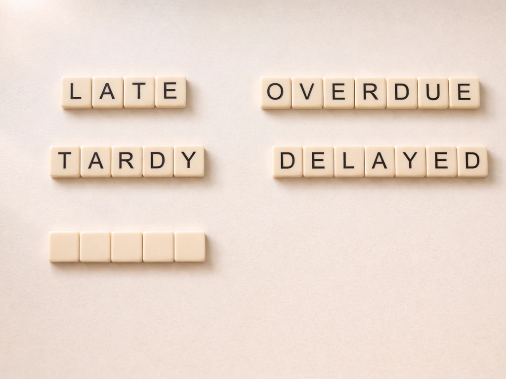Minimal tabletop photo of letter tiles spelling LATE, TARDY, OVERDUE, and DELAYED side-by-side.