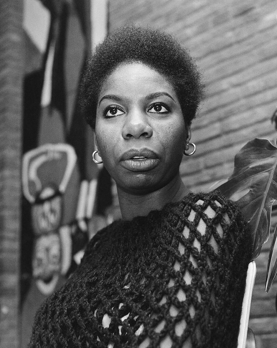 Black-and-white portrait photo of Nina Simone looking off-camera