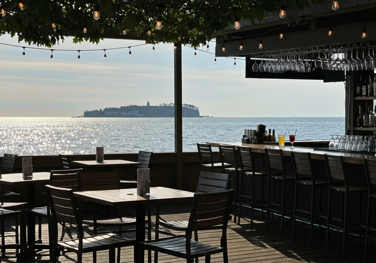 Lively waterfront patio bar with patio seating and a distant view of Mackinac Island.