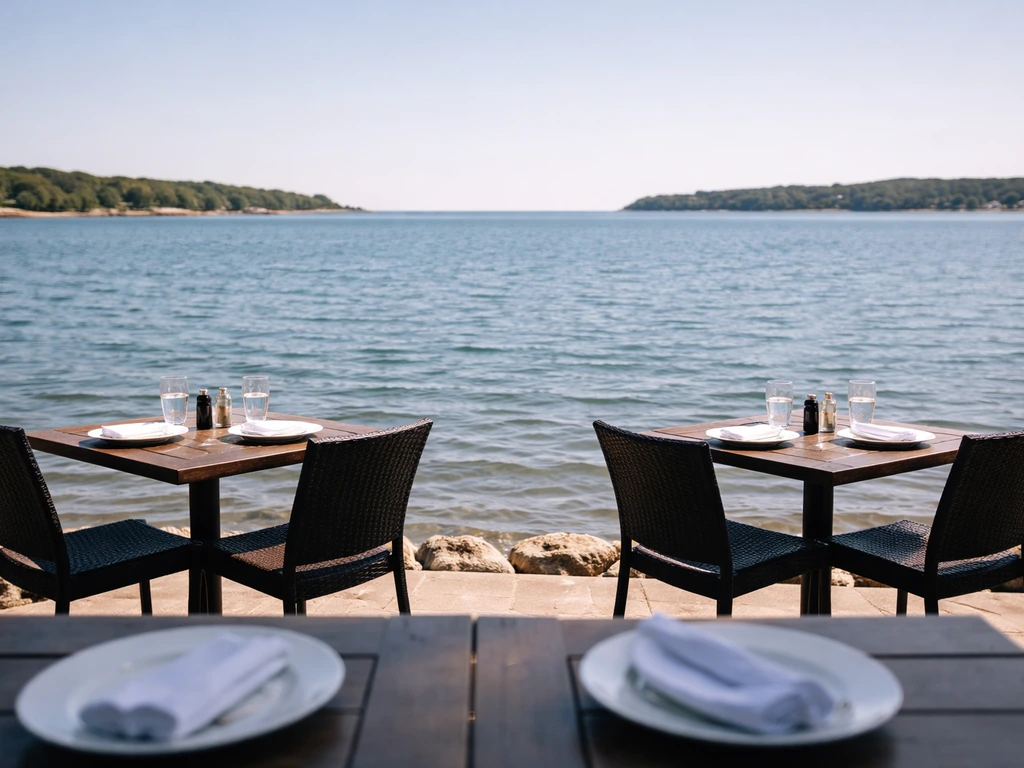 Minimal waterfront patio with outdoor tables overlooking Onset Bay.