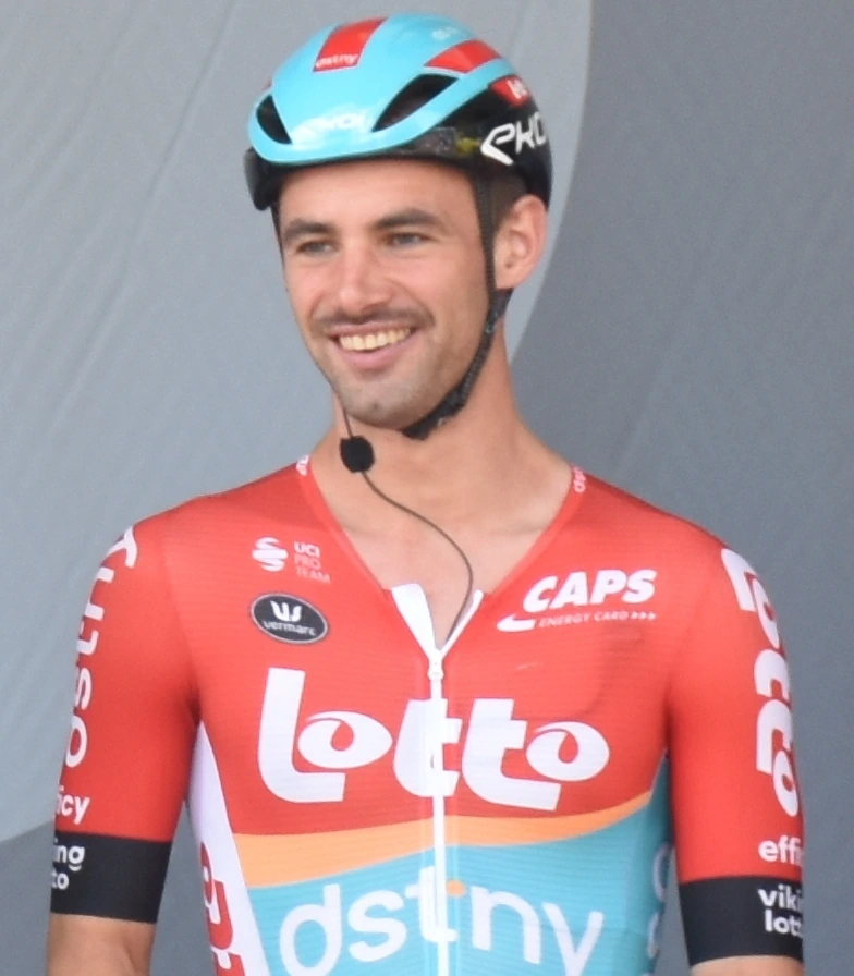 Victor Campenaerts smiling in a Lotto–Dstny cycling jersey and helmet