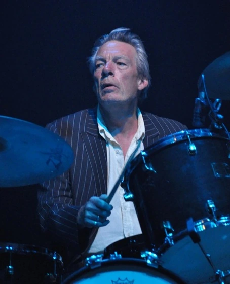 Andrew Ranken playing drums on stage with The Pogues