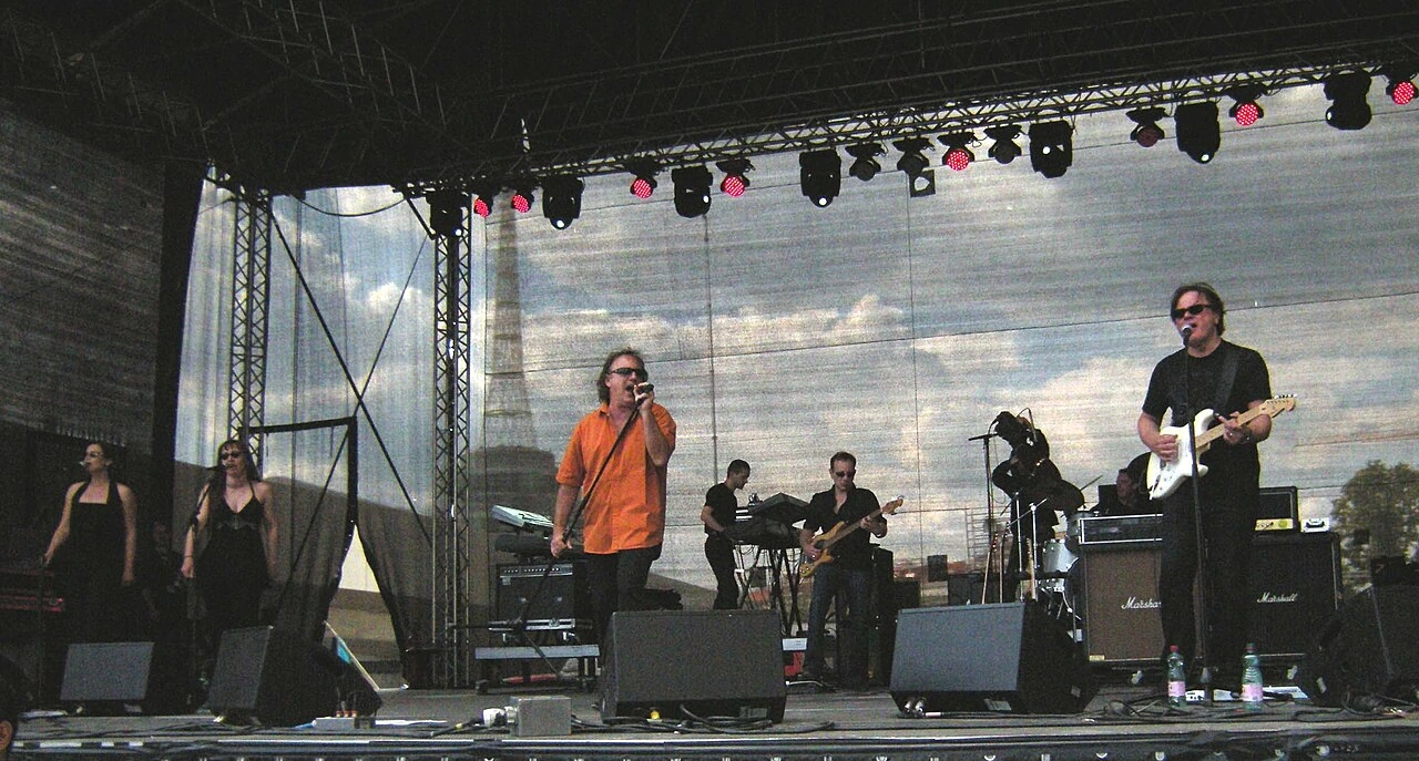 Opus performing on stage in a live concert photo
