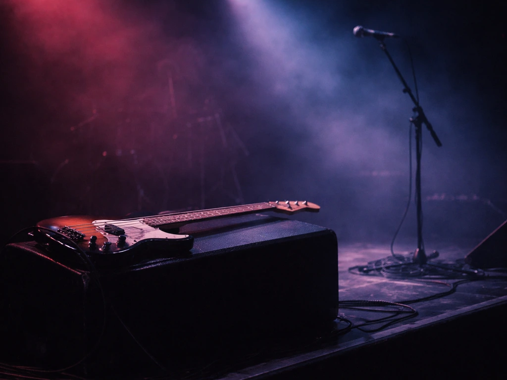 Dim stage lit with magenta and blue lights, showing an unbranded bass guitar on a monitor.