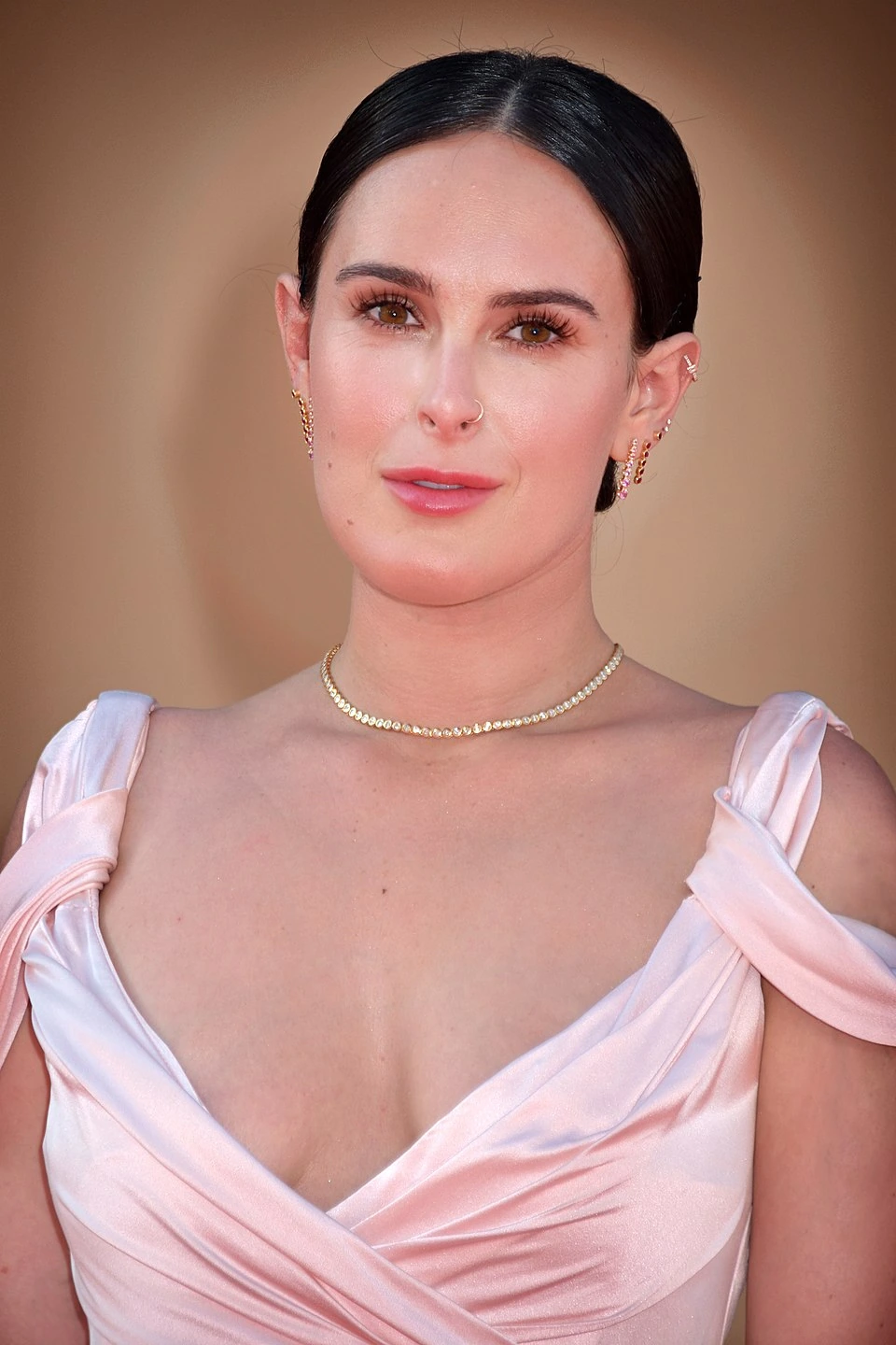 Rumer Willis posing at a red carpet event in a formal dress