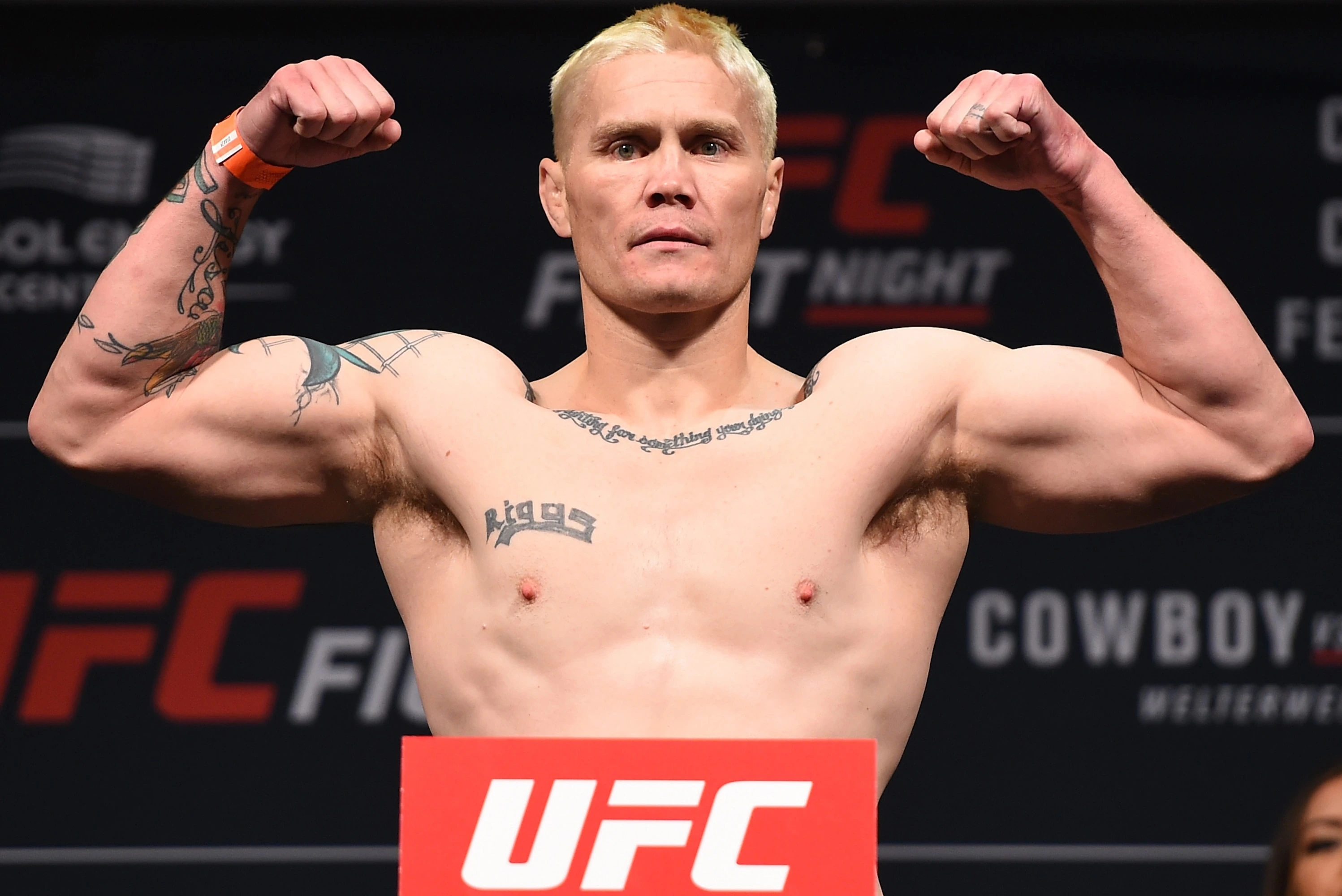 Joseph Jonathan Riggs posing on stage at a UFC event