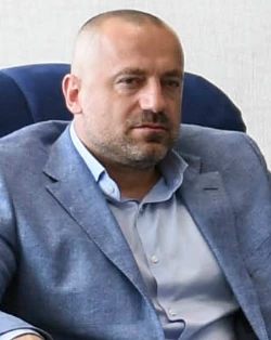 Milan Radoičić seated in a suit, portrait photo