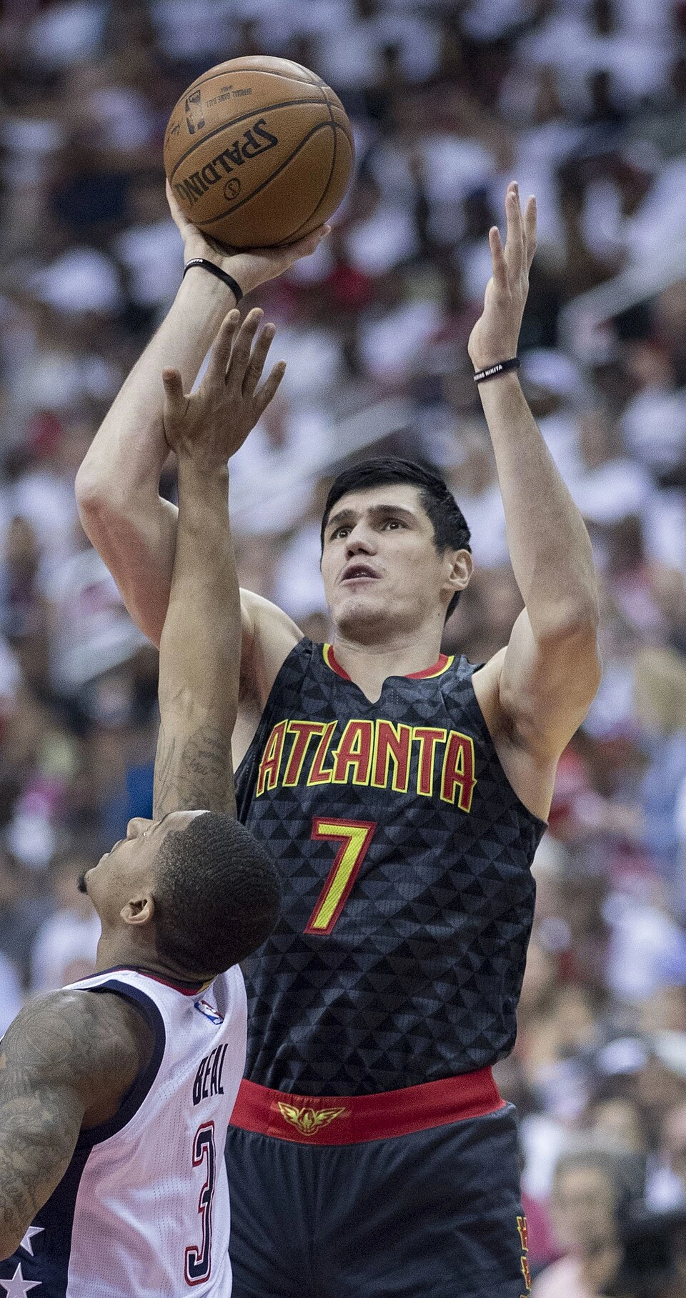 Ersan İlyasova in an Atlanta Hawks jersey shooting over a defender during a basketball game