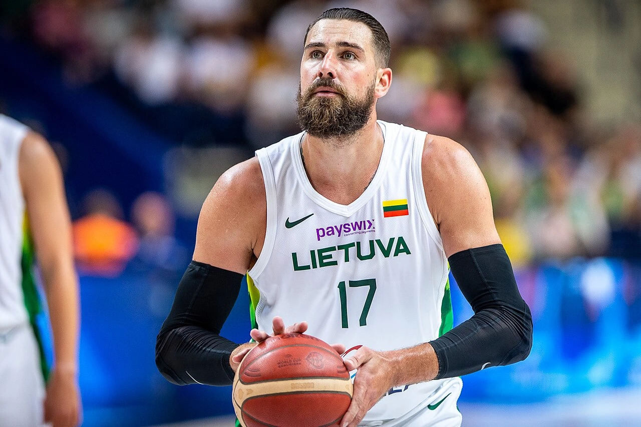 Jonas Valančiūnas in a Lithuania basketball uniform holding a ball during a game
