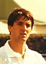 Slobodan Živojinović, Serbian tennis player, in a candid sports photo wearing a white shirt.