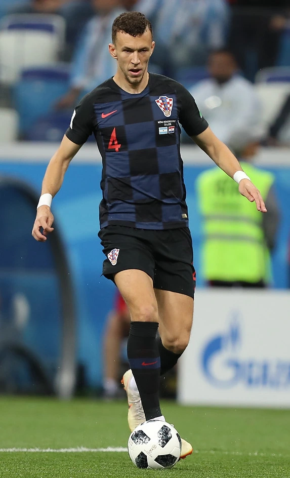 Ivan Perišić in a Croatia national team match, controlling the ball on the pitch.