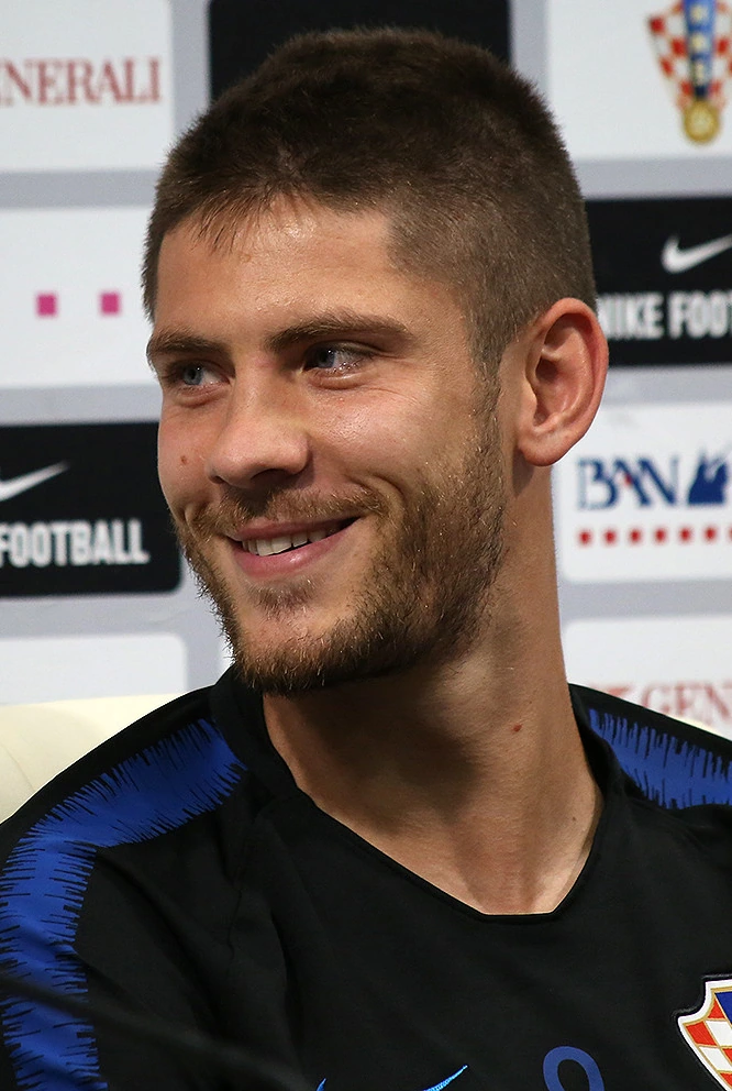 Andrej Kramarić smiling in a Croatia football shirt during a media interview