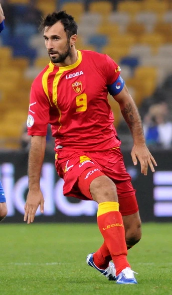 Mirko Vučinić in a red Montenegro football kit during a match