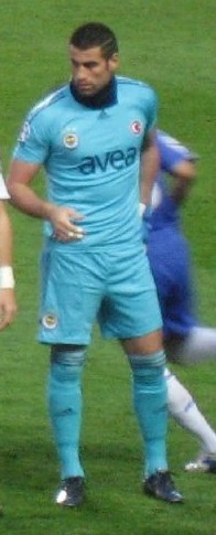 Volkan Demirel in action as a football goalkeeper, diving to make a save