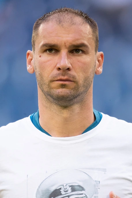 Head-and-shoulders portrait of Branislav Ivanović in a white shirt against a blurred blue background.