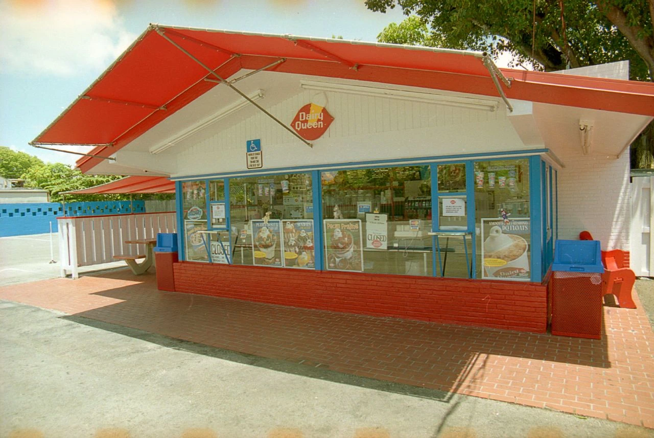 A Dairy Queen restaurant storefront with the brand’s red, white, and blue signage and awning.