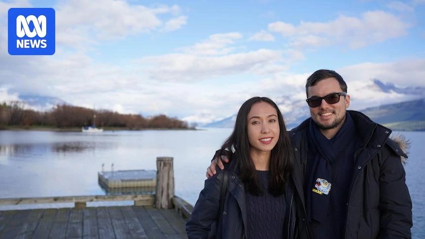 Queenie Tan standing outdoors by a lakeside with another person in an ABC News photo.