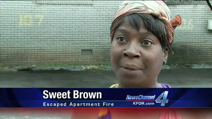 Sweet Brown speaking in a news interview frame after the Oklahoma City apartment fire viral video.