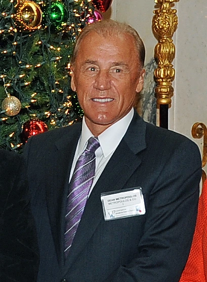 Dean Metropoulos, business investor and founder of Metropoulos & Co., in a suit and tie at an event.