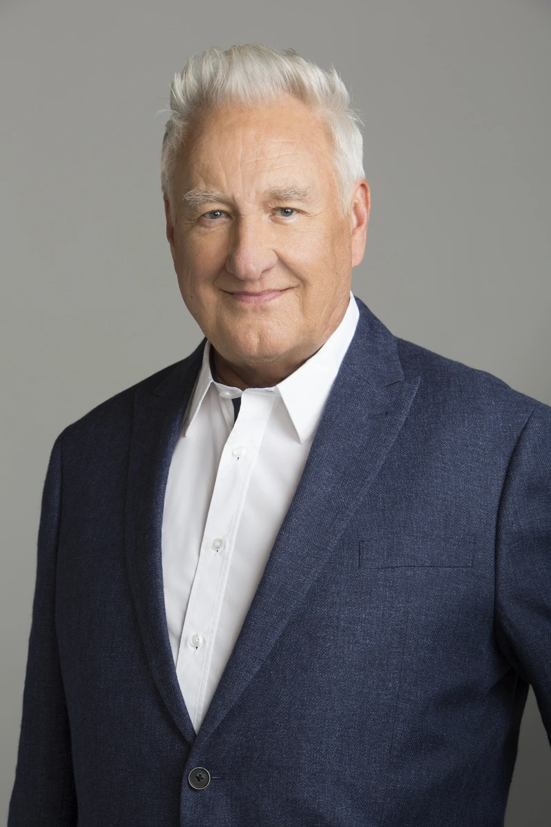 Portrait photo of Don Mischer in a suit against a plain background.