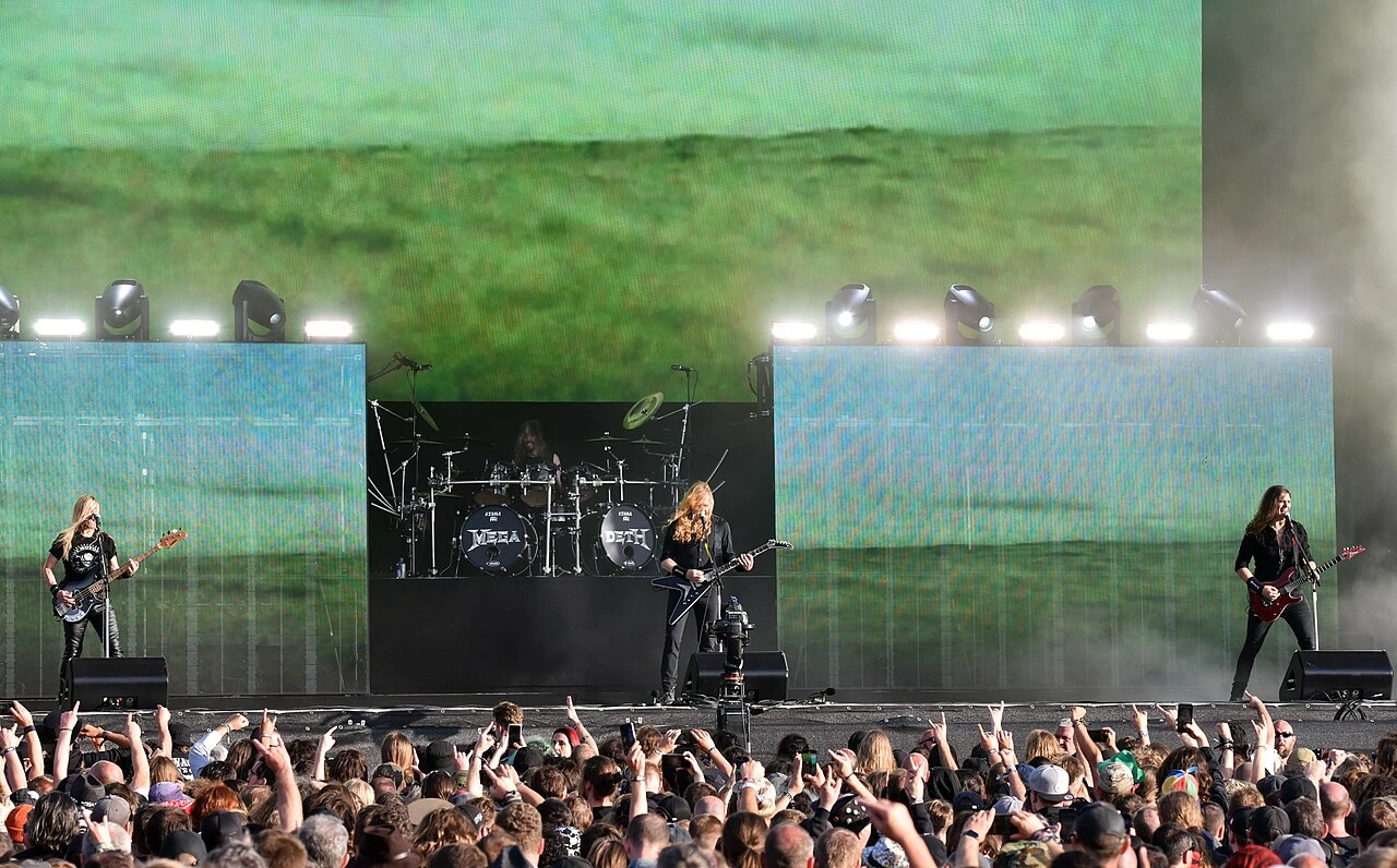 Megadeth performing live on stage at Wacken Open Air 2023, with the drummer visible at the center of the stage behind th