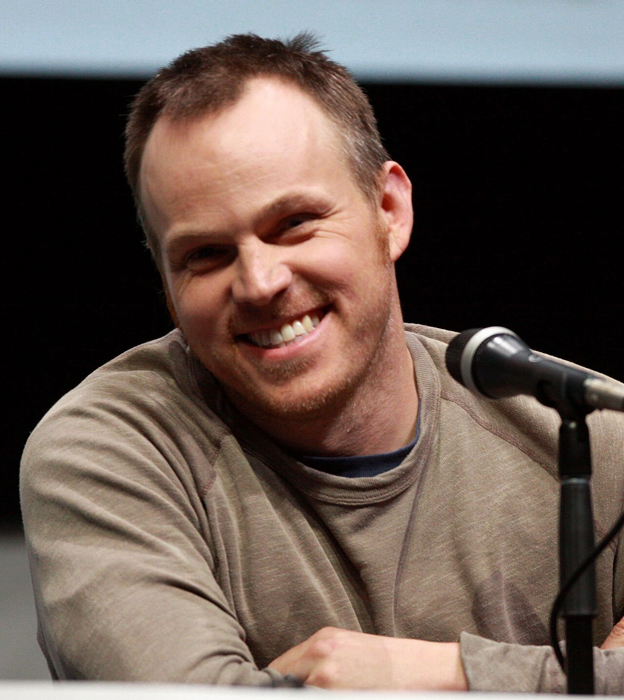 Marc Webb smiling at a microphone during a panel discussion