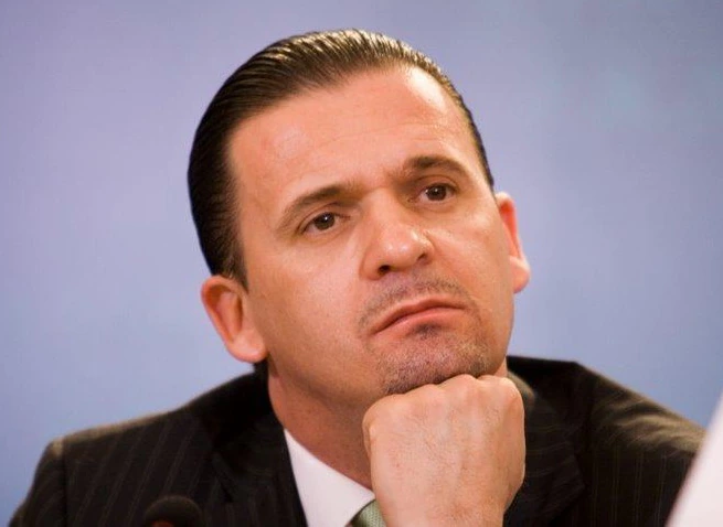 Predrag Mijatović seated at a press conference, resting his chin on his hand