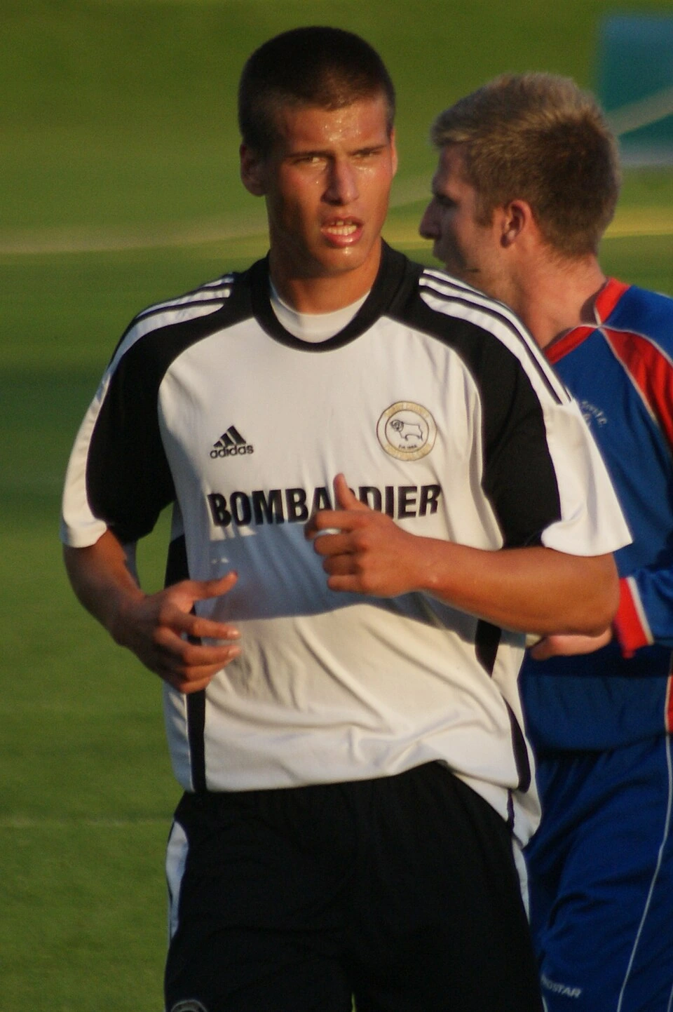 Aleksandar Prijović in a football match, wearing a white and black jersey