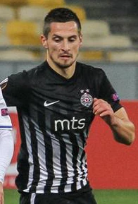 Footballer in a black-and-white striped jersey during a match