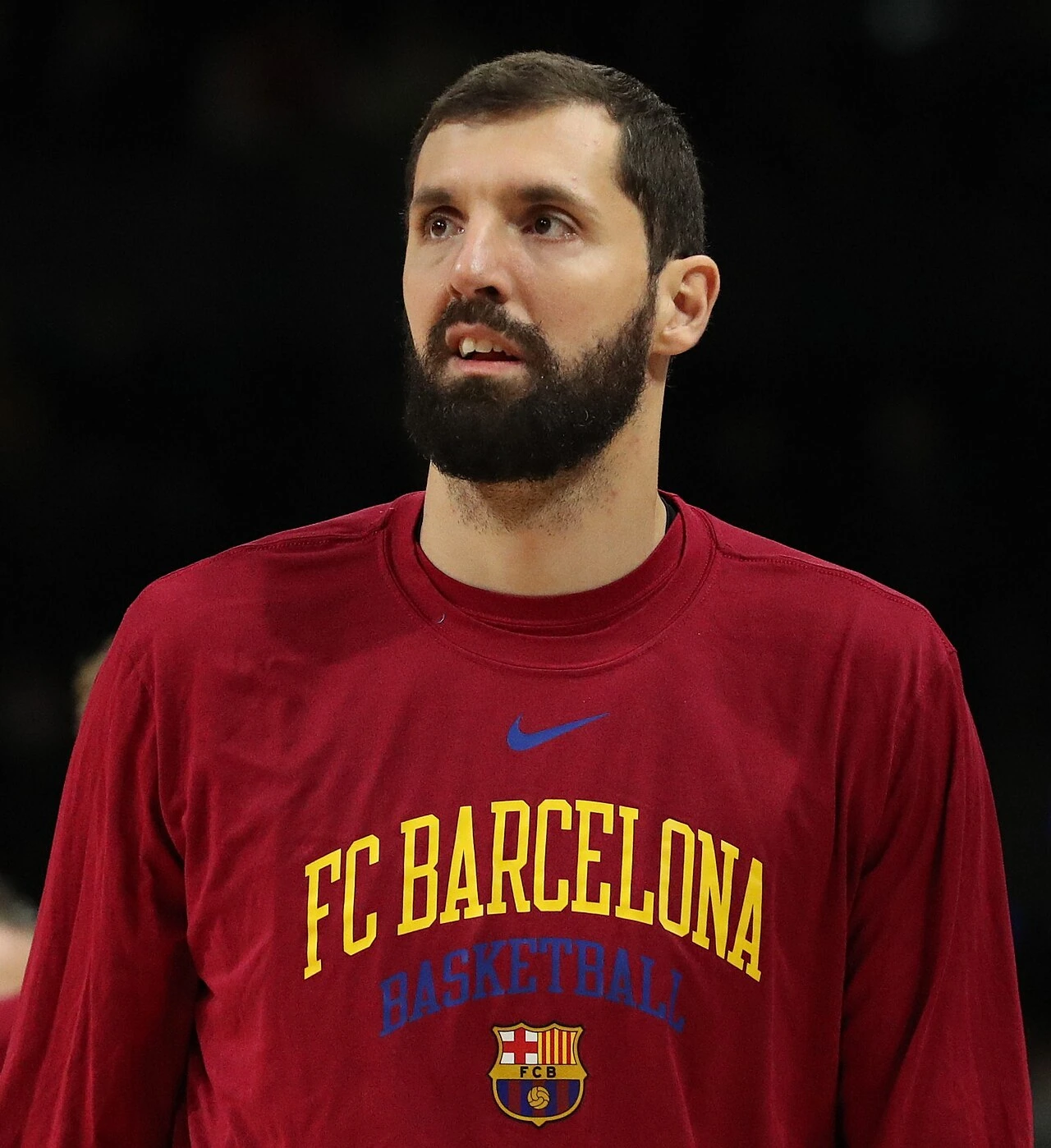 Nikola Mirotić in a red FC Barcelona basketball warm-up shirt