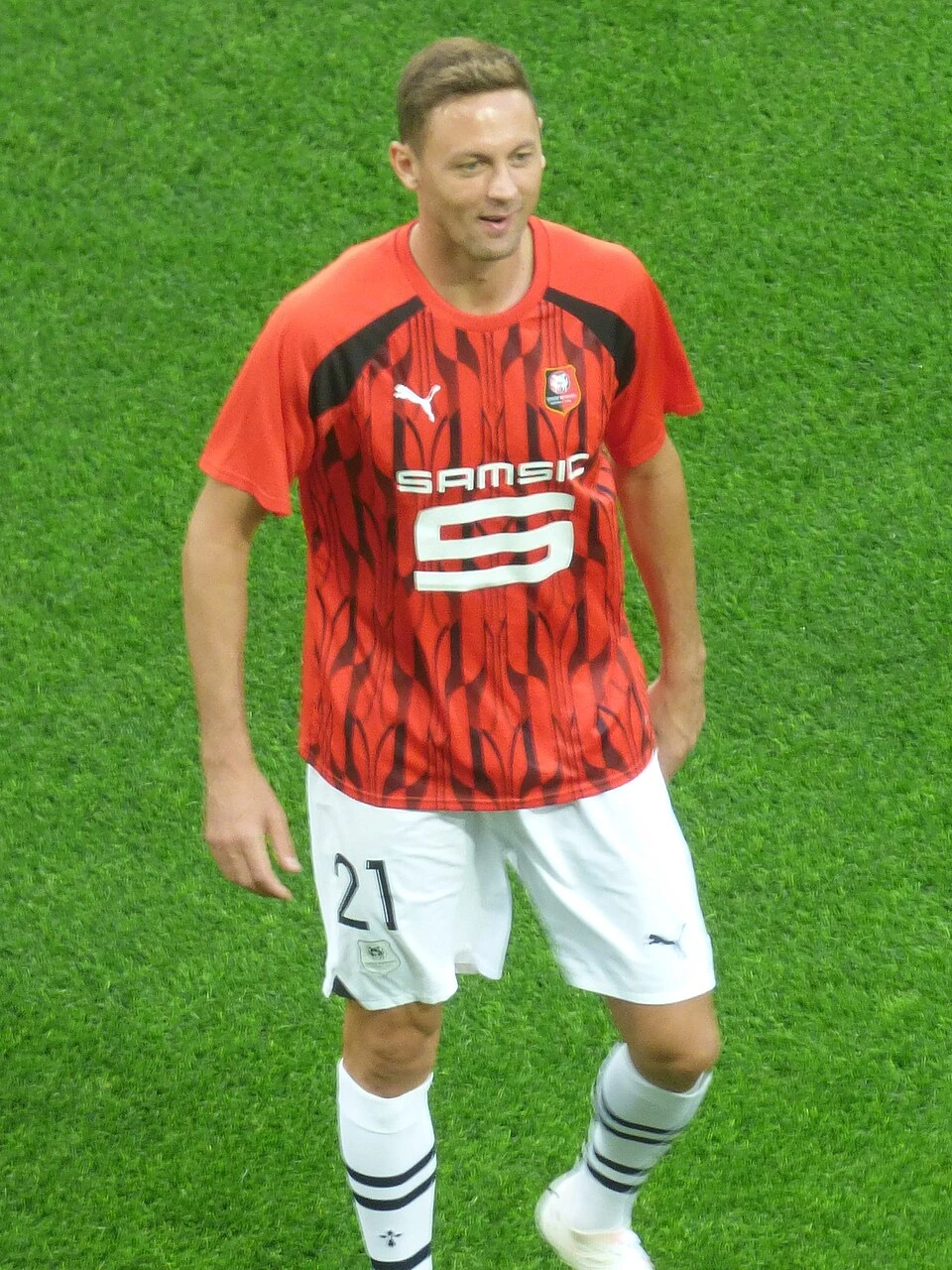 Nemanja Matić in a red football kit standing on the pitch