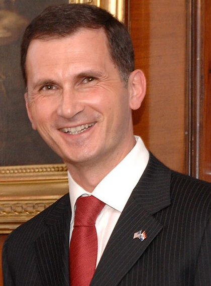 Dragan Primorac in a suit and red tie, smiling for a portrait