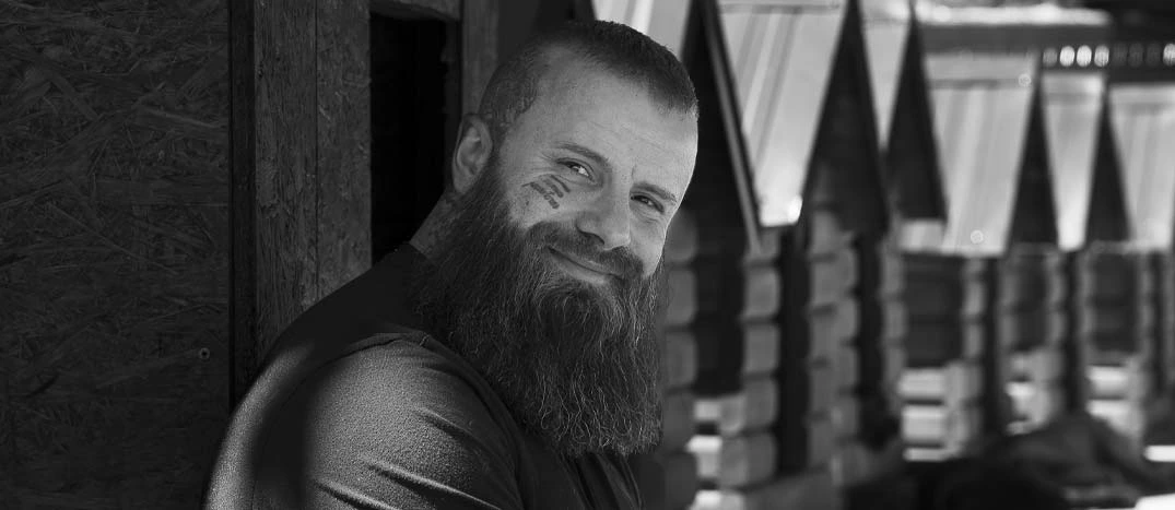 Black-and-white portrait of Bruno Jeliović smiling outdoors
