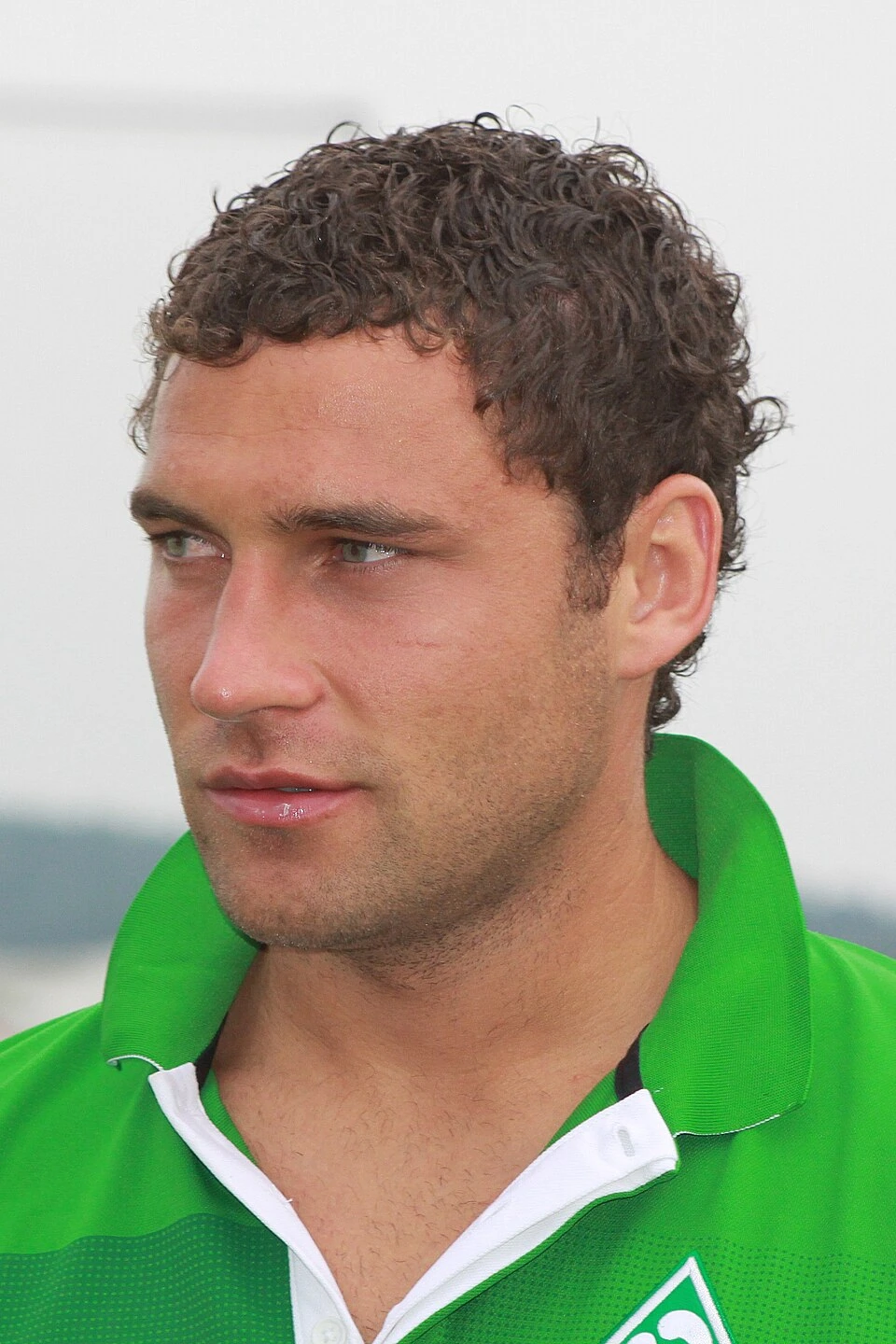 Duško Tošić in a green football shirt