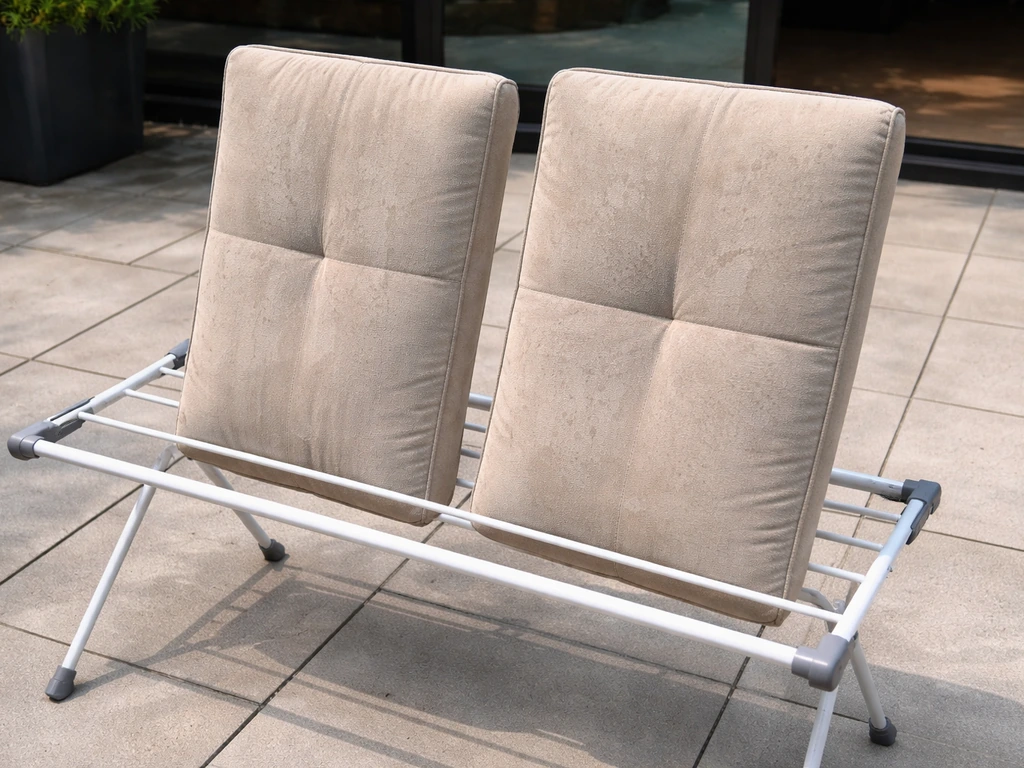 Cushions drying upright on their edges on a patio drying rack with airflow