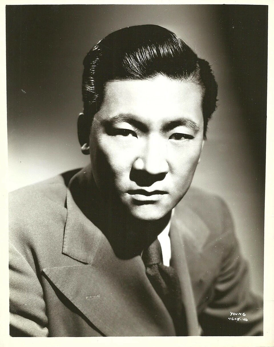 Black-and-white press photo portrait of Victor Sen Yung in a suit.