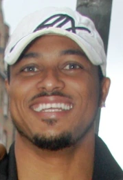 Portrait photo of Joseph van Vicker smiling in a cap