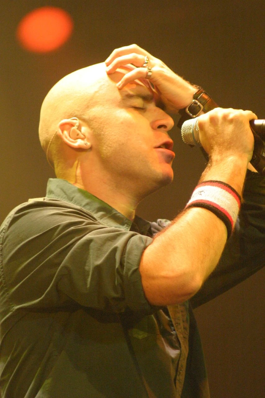 Ed Kowalczyk performing on stage with a microphone