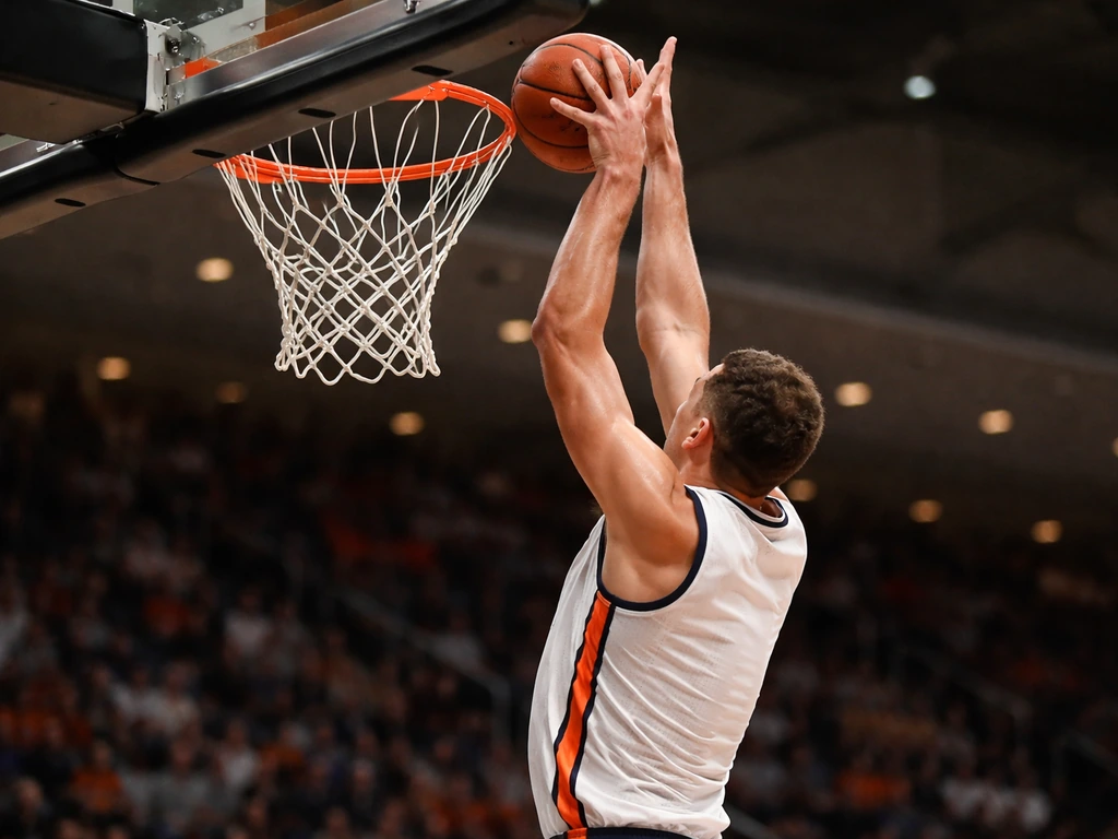 Anonymous Auburn-style shot-blocker jumps to block a basketball near the rim in an indoor arena.
