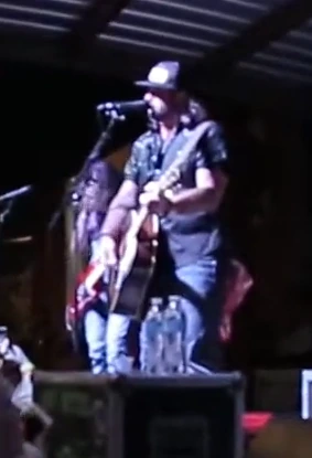 Koe Wetzel performing on stage with a guitar