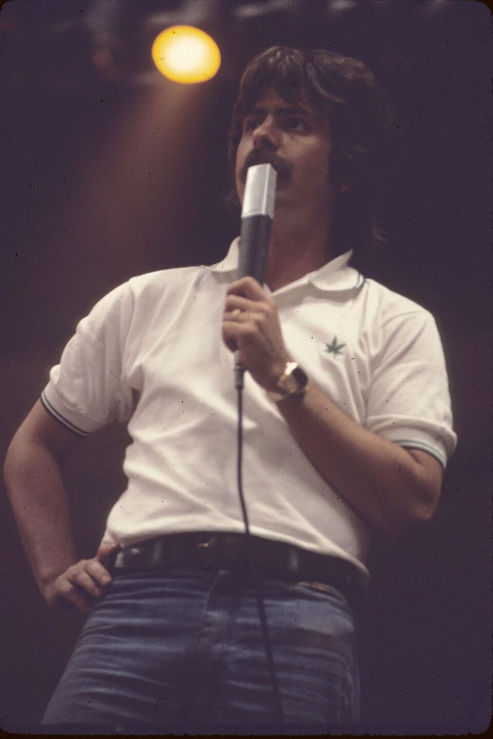 Jim Koplik speaking into a microphone on stage