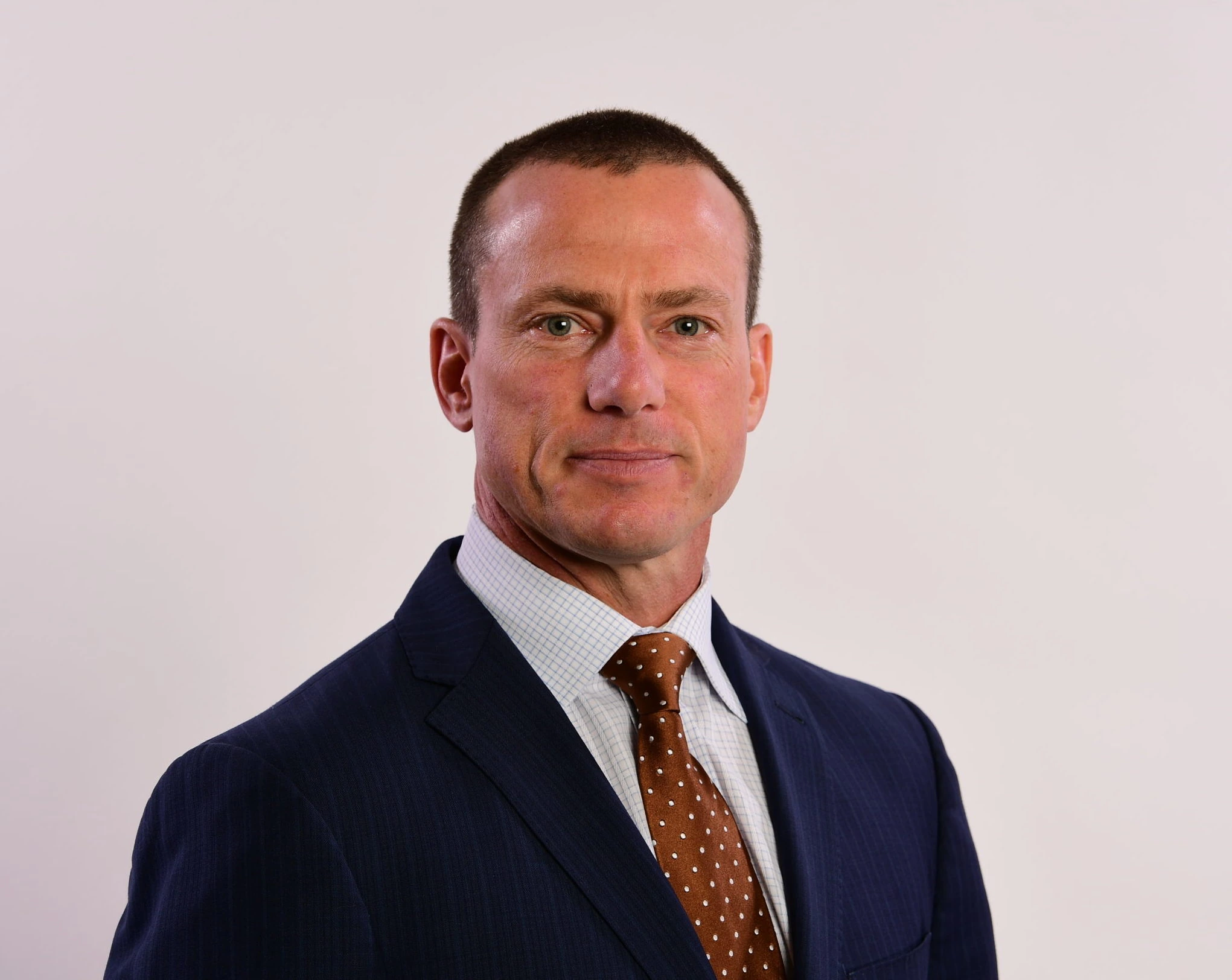 Portrait of Quint Kessenich in a suit
