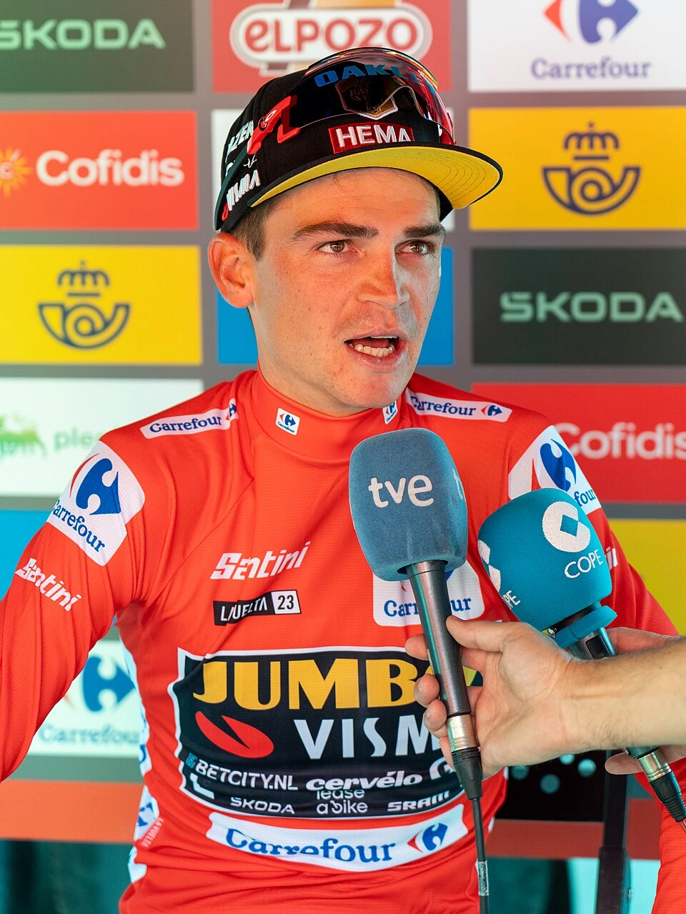 Sepp Kuss in Jumbo-Visma cycling kit speaking to reporters after a race