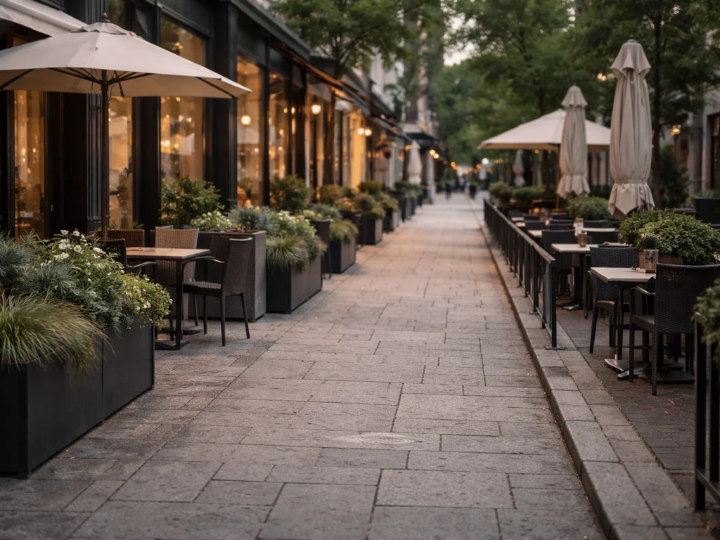 Upscale Yorkville Avenue streetscape with curbside patios, planters, and umbrellas along the sidewalk.