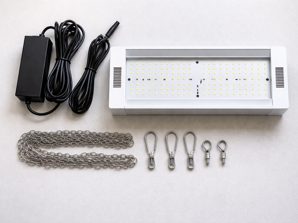 Top-down view of a grow light fixture and mounting hardware neatly laid out during unboxing