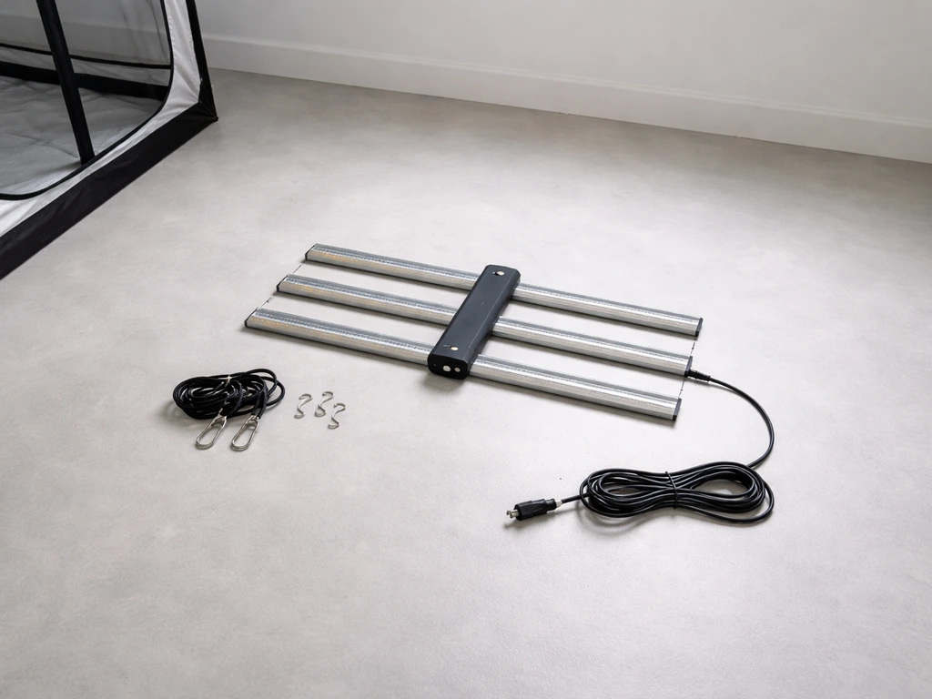 Grow tent setup area with grow fixture, rope hangers, hooks, and power cord neatly laid out